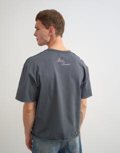Model wearing Topman x Akilah relaxed fit abstract portrait graphic t-shirt with embroidery in charcoal