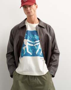Model wearing X Jing boxy fit crop abstract breaking free graphic t-shirt with embroidery in ecru