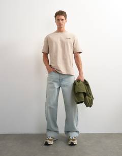 Model wearing Topman x Paul Majek relaxed fit abstract painting back graphic t-shirt with embroidery in stone