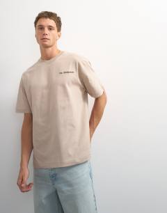 Model wearing Topman x Paul Majek relaxed fit abstract painting back graphic t-shirt with embroidery in stone