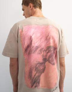Model wearing Topman x Paul Majek relaxed fit abstract painting back graphic t-shirt with embroidery in stone