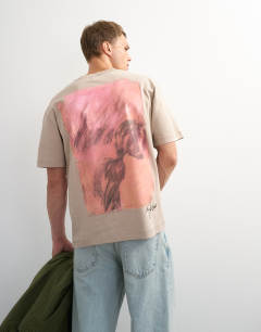 Model wearing Topman x Paul Majek relaxed fit abstract painting back graphic t-shirt with embroidery in stone