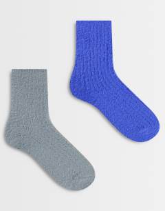 Model wearing 2pk cosy fluffy socks in grey and cobalt