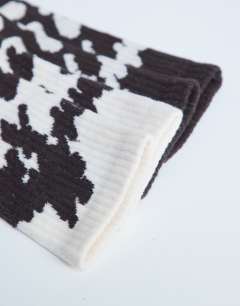 Model wearing 2pk sporty rib cow print socks in choc and cream cow