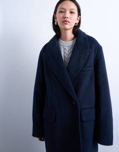 Model wearing 3 button brushed coat with wool in navy