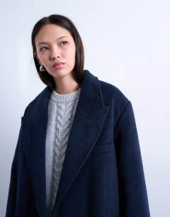Model wearing 3 button brushed coat with wool in navy