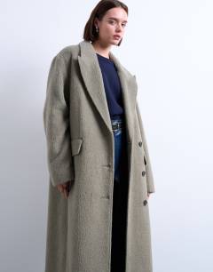 Model wearing 3 button brushed coat with wool in sage