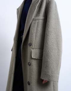 Model wearing 3 button brushed coat with wool in sage