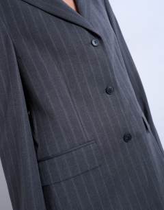 Model wearing 3 button mensy pinstripe blazer co-ord in charcoal