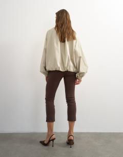 Model wearing 3 quarter length capri in brown