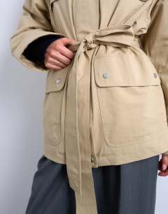 Model wearing 4 pocket cotton shacket with quilted lining in beige