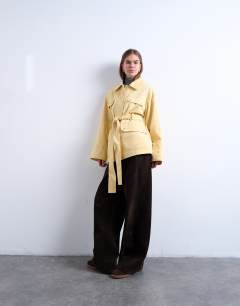 Model wearing 4 pocket cotton shacket with quilted lining in butter yellow