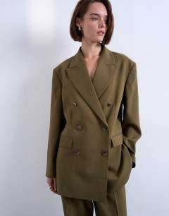 Model wearing 6 button double breasted tuxedo blazer in khaki