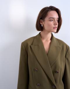 Model wearing 6 button double breasted tuxedo blazer in khaki