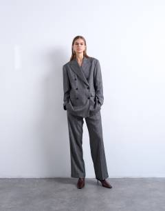 Model wearing 6 button herringbone stripe double breasted tuxedo blazer in grey