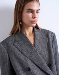 Model wearing 6 button herringbone stripe double breasted tuxedo blazer in grey