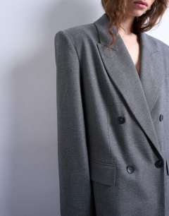 Model wearing 80s double breasted oversized blazer in grey
