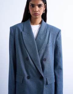 Model wearing 80s double breasted oversized suit blazer in navy