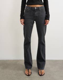 Model wearing 90's bootcut low rise jean in washed black