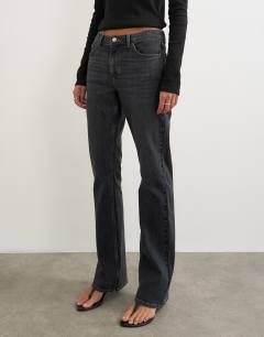 Model wearing 90's bootcut low rise jean in washed black