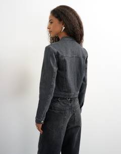 Model wearing 90s fitted jacked in washed black 