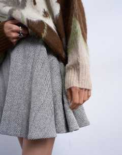 Model wearing A-line flippy mini skirt in mono herringbone