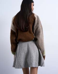 Model wearing A-line flippy mini skirt in mono herringbone