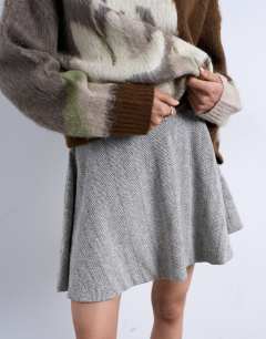 Model wearing A-line flippy mini skirt in mono herringbone