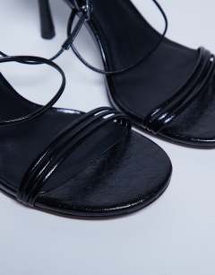 Model wearing Abbie strappy mid heel sandal in black