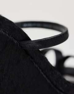 Model wearing Abi strappy wedge heel in black hair on real leather