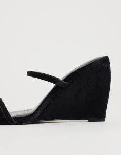 Model wearing Abi strappy wedge heel in black hair on real leather