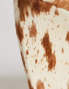 Model wearing Abi strappy wedge heel in cow print hair on real leather