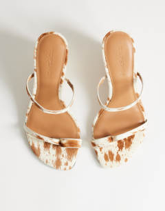 Model wearing Abi strappy wedge heel in cow print hair on real leather