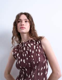 Model wearing Abstract animal print plisse mini dress in brown