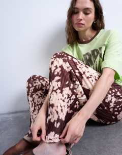 Model wearing Abstract animal print plisse trousers in brown