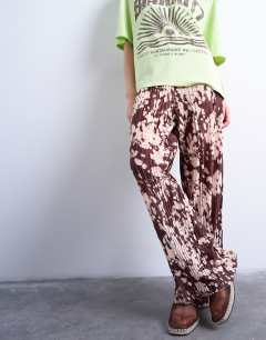 Model wearing Abstract animal print plisse trousers in brown