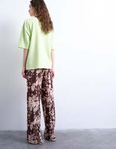 Model wearing Abstract animal print plisse trousers in brown