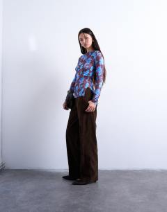 Model wearing Abstract floral print slash neck long sleeve top in blue