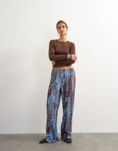 Model wearing Abstract plisse wide leg trouser in blue