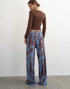 Model wearing Abstract plisse wide leg trouser in blue
