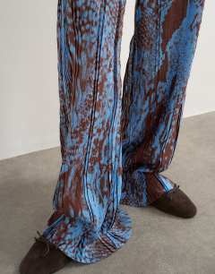Model wearing Abstract plisse wide leg trouser in blue