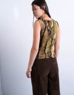 Model wearing Abstract print asymmetric wrap detail top in brown