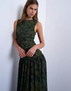 Model wearing Abstract print dropped waist maxi dress in green