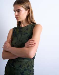 Model wearing Abstract print dropped waist maxi dress in green