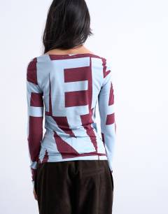 Model wearing Abstract print long sleeve top in blue and burgundy