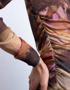 Model wearing Abstract print ruched long sleeve top in multi