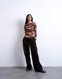 Model wearing Abstract print ruched long sleeve top in multi