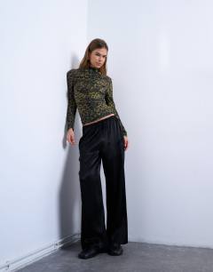 Model wearing Abstract spot print ruched long sleeve top in black