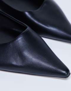 Model wearing Ace point toe flat shoe in black