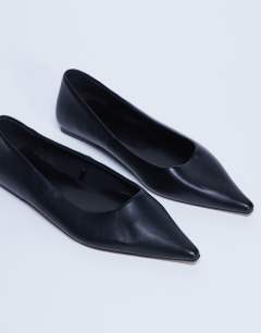 Model wearing Ace point toe flat shoe in black